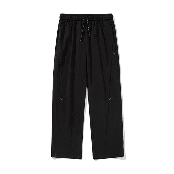 Unisex Wide water-repellent nylon leisure pants with elastic waistband and snap-button hem Mune Fashion