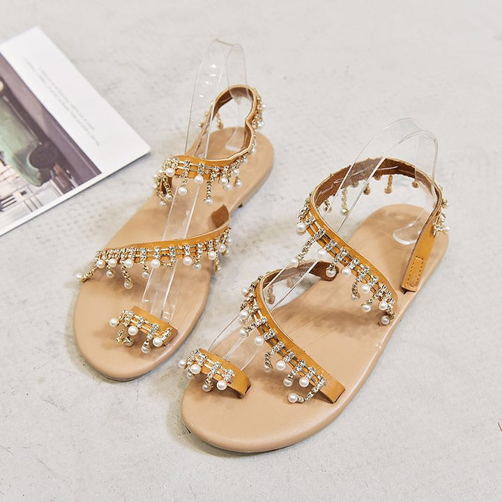 Ladies' filigree ankle strap sandal with sparkling rhinestone and pearl details, toe post, adjustable heel strap, and padded comfort footbed Mune Fashion
