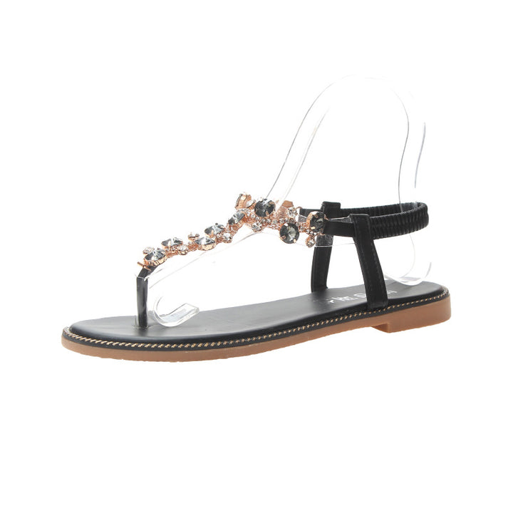 Women's flat T-strap sandals with sparkly jewelry chain, elastic heel strap, and padded footbed Mune Fashion
