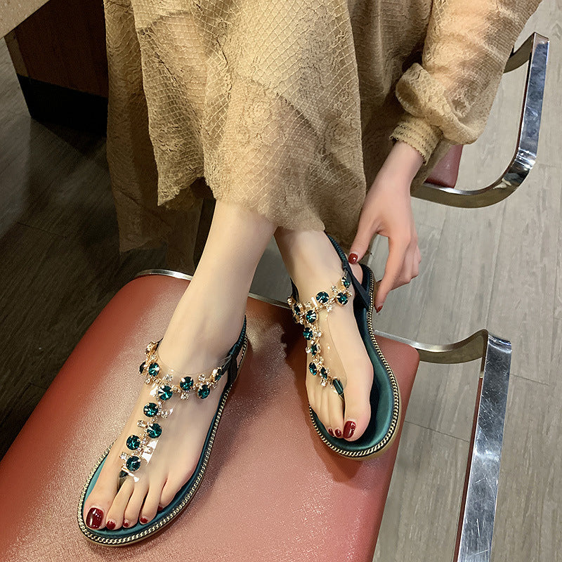 Women's flat T-strap sandals with sparkly jewelry chain, elastic heel strap, and padded footbed Mune Fashion