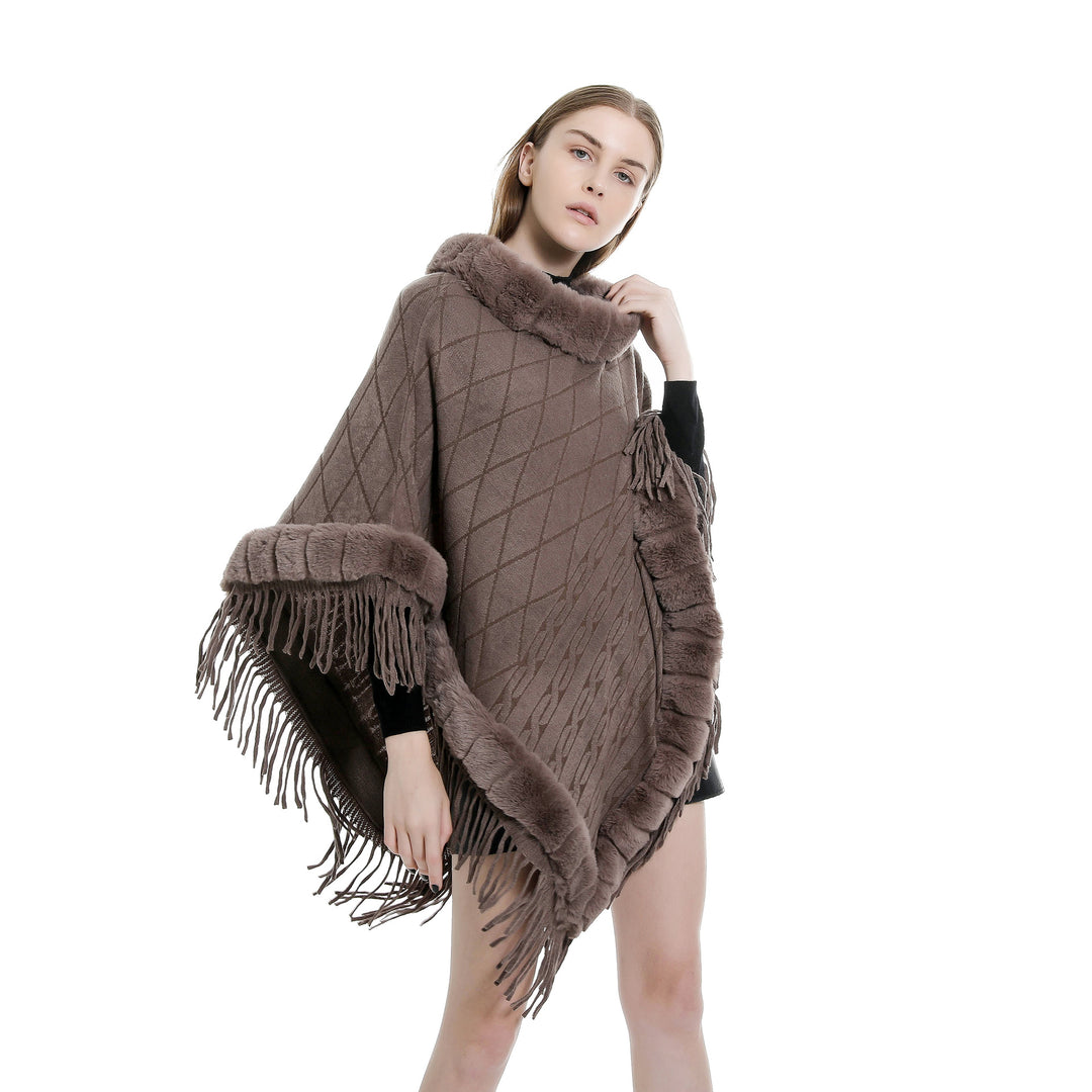 Women's wool look ruana with faux fur collar, fringed hem, and oversized drape.