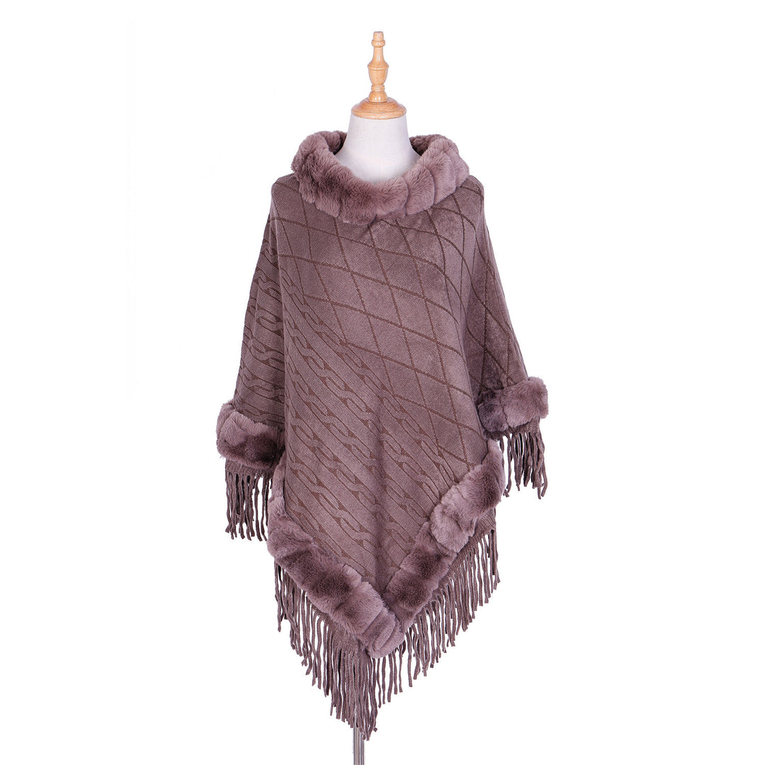 Women's wool look ruana with faux fur collar, fringed hem, and oversized drape.