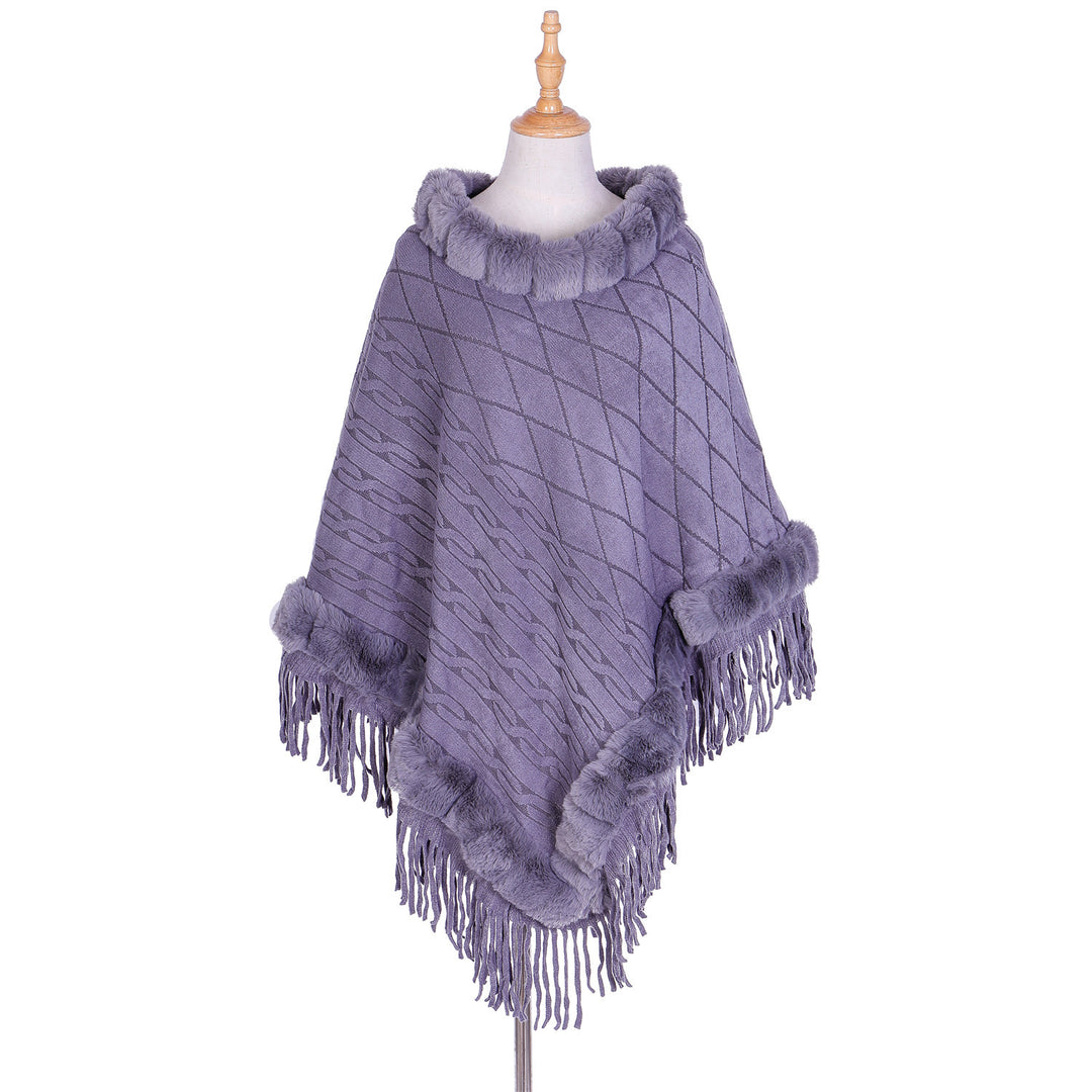 Women's wool look ruana with faux fur collar, fringed hem, and oversized drape.