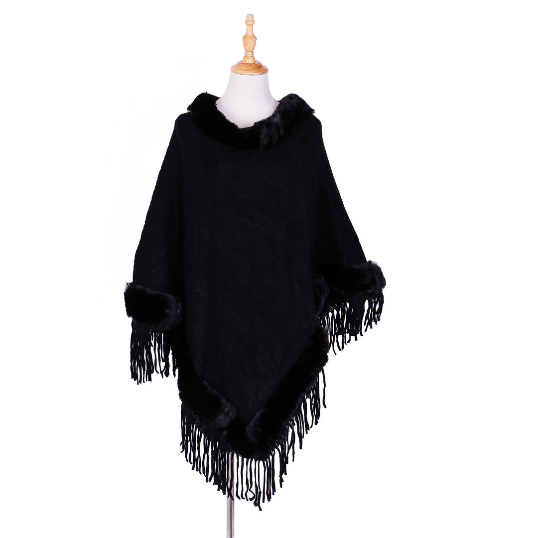 Women's wool look ruana with faux fur collar, fringed hem, and oversized drape.