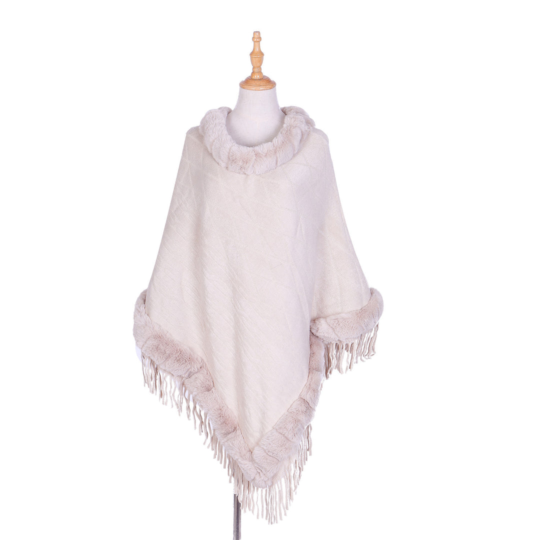 Women's wool look ruana with faux fur collar, fringed hem, and oversized drape.