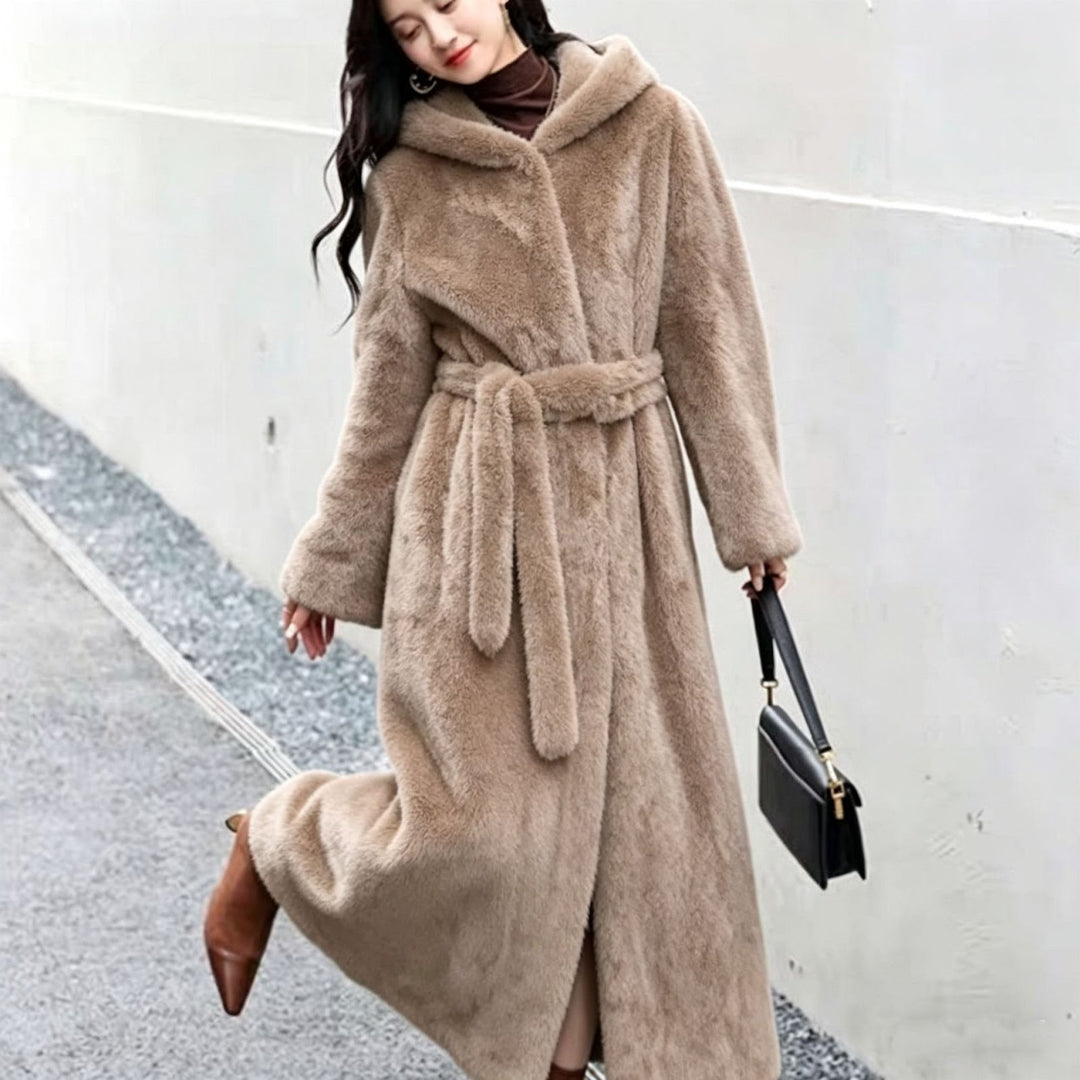 Long women's coat made of faux fur with hood