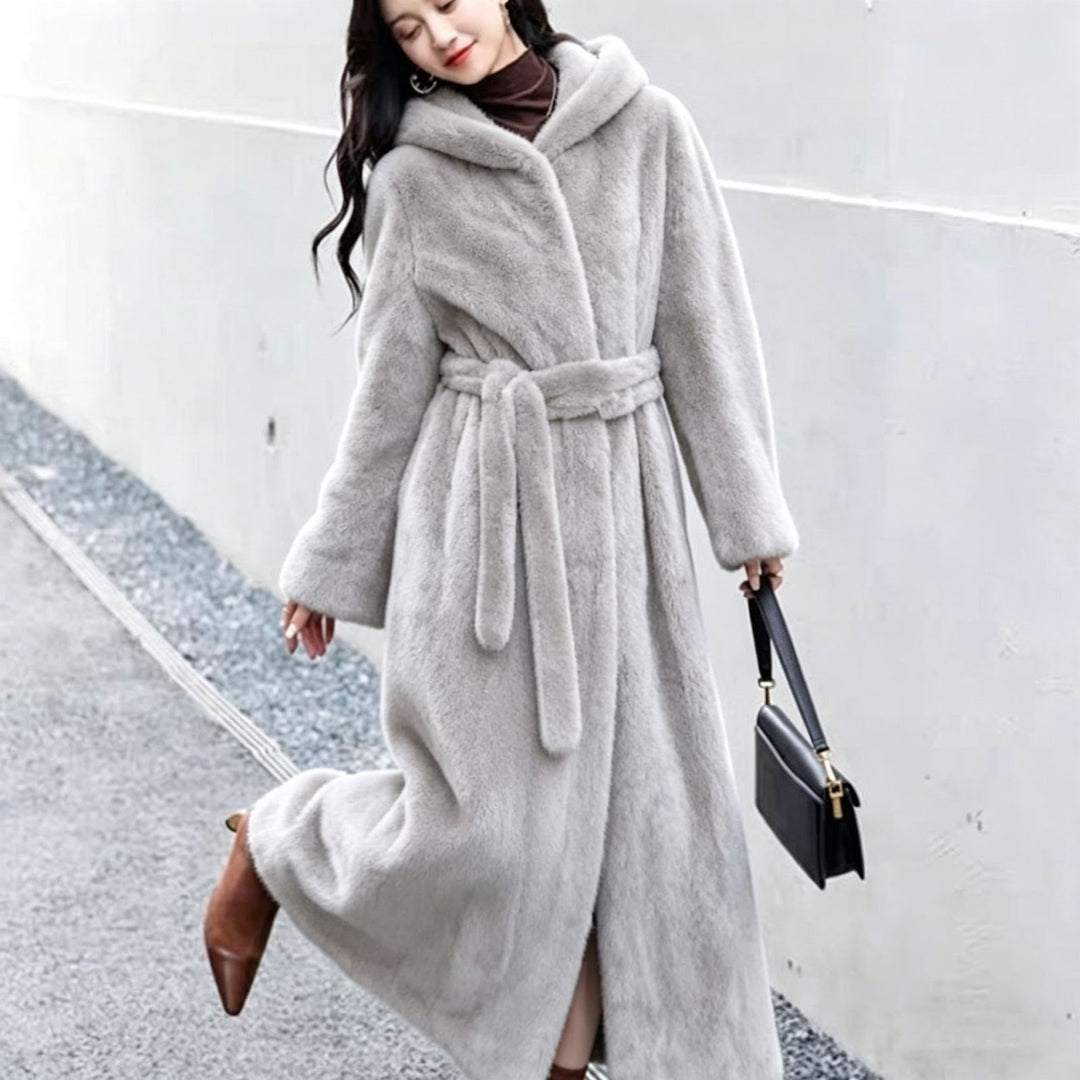 Long women's coat made of faux fur with hood