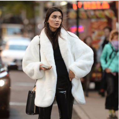 Elegant women's faux fur coat, fluffy