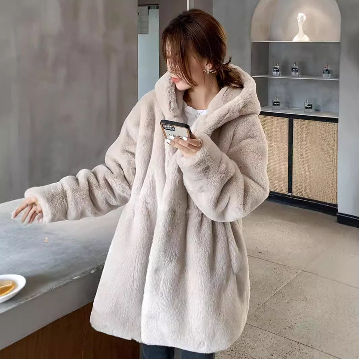Long women's faux fur coat with hood and tailoring