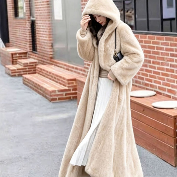 Long women's coat made of faux fur with hood