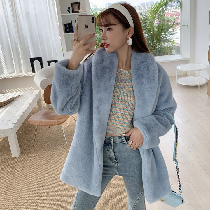 Elegant women's faux fur coat, fluffy