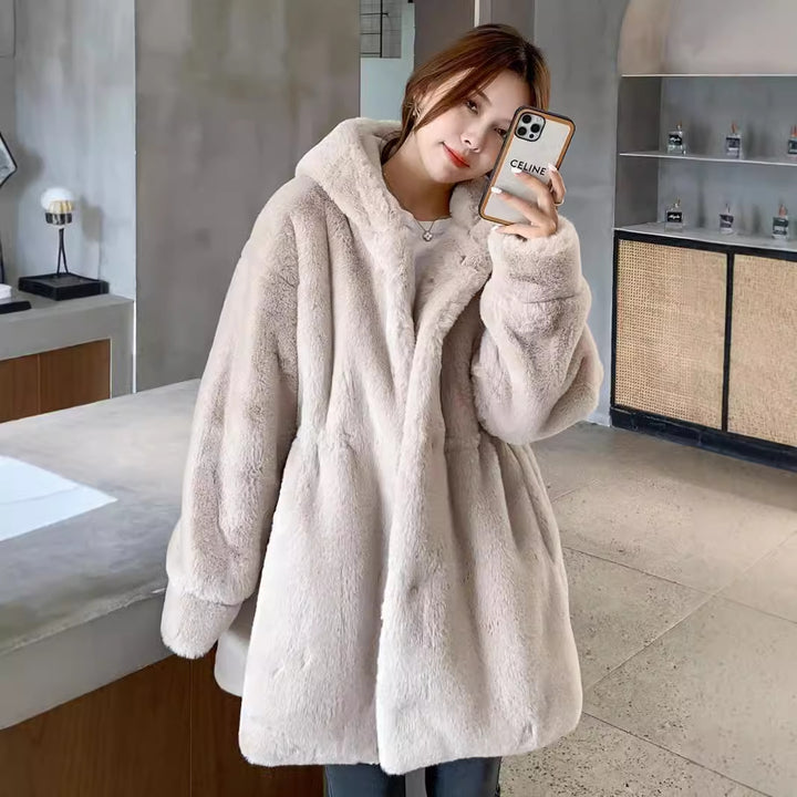 Long women's faux fur coat with hood and tailoring
