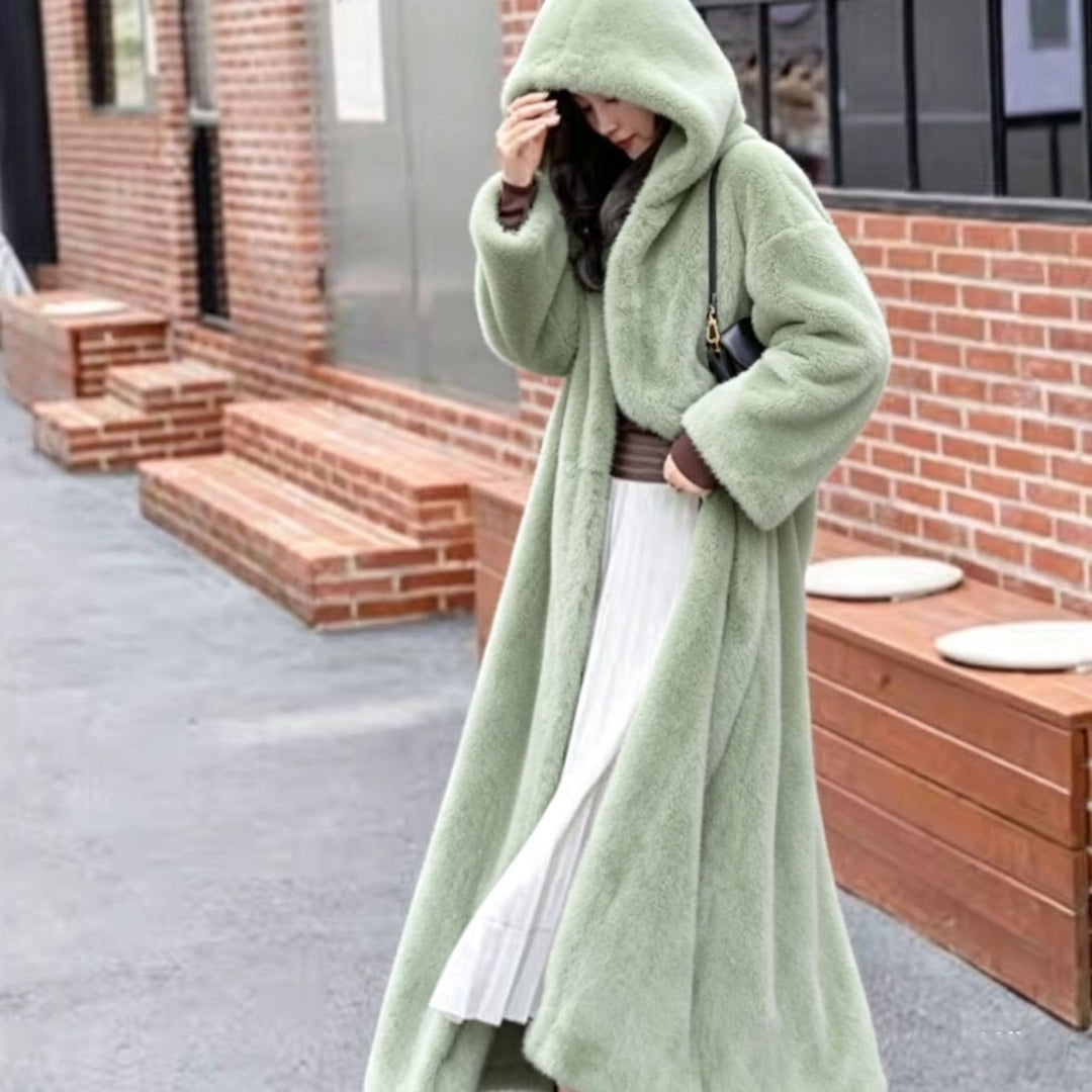 Long women's coat made of faux fur with hood