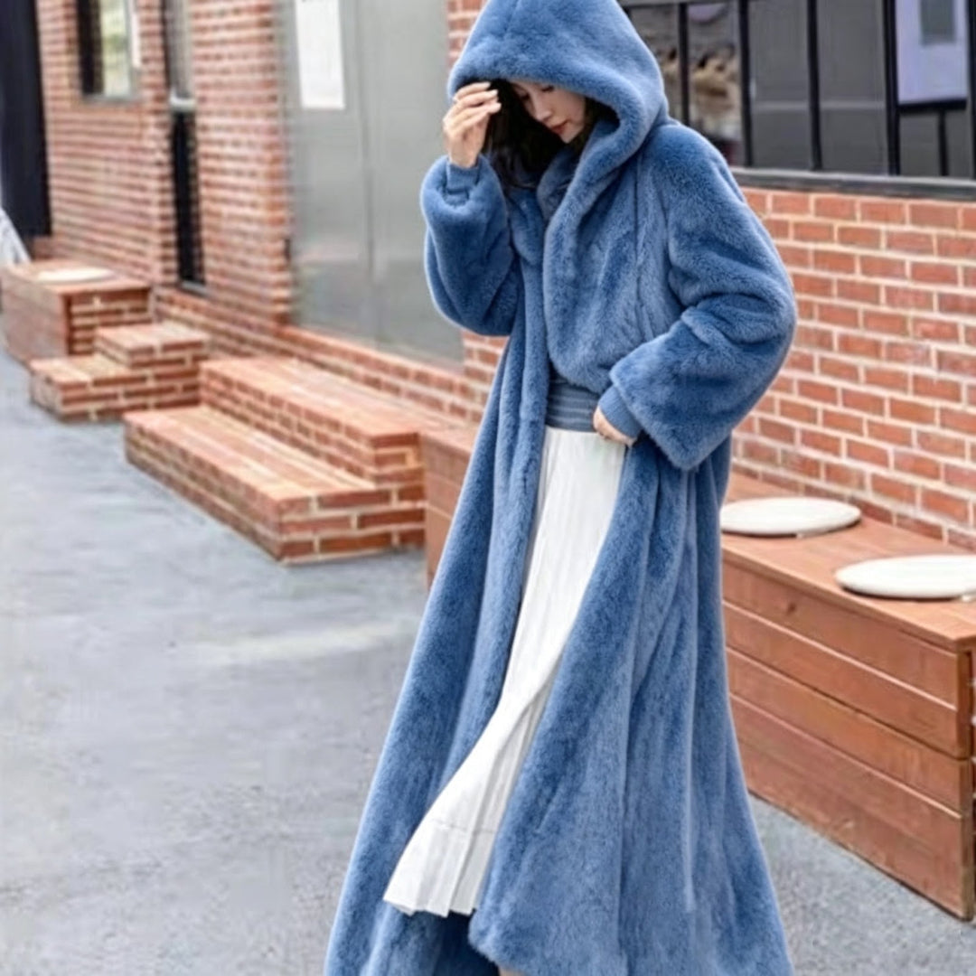Long women's coat made of faux fur with hood