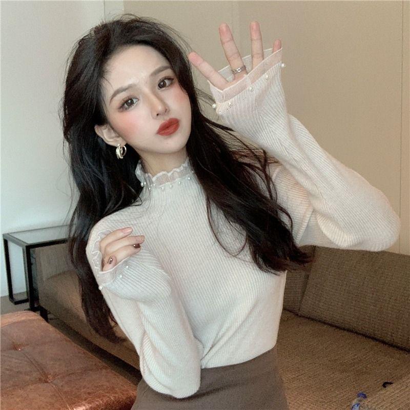 Women's knitted pullover with stand collar and pearl details