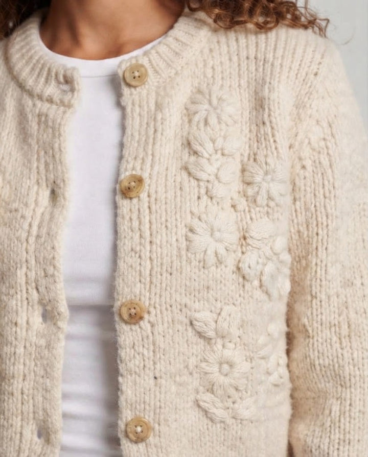 Women's chunky knit cardigan with bobble details, round neckline, and mother-of-pearl button placket Mune Fashion
