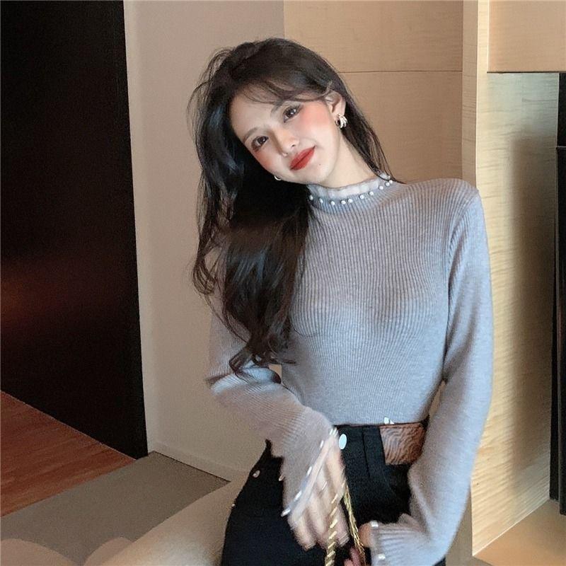 Women's knitted pullover with stand collar and pearl details