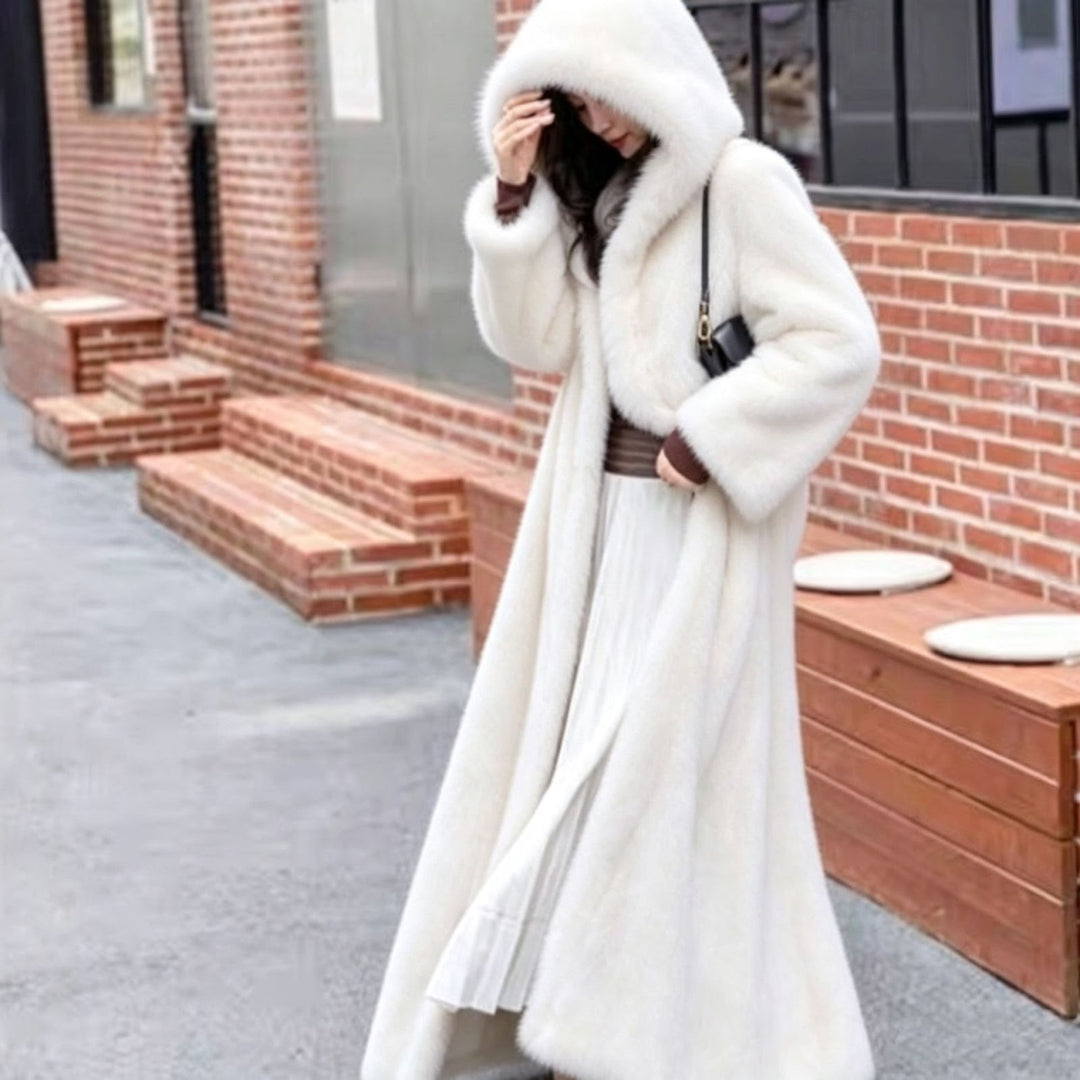 Long women's coat made of faux fur with hood