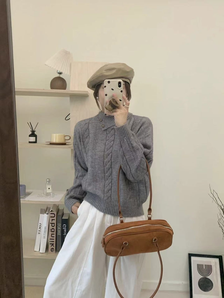 Short cable knit sweater with asymmetric neckline