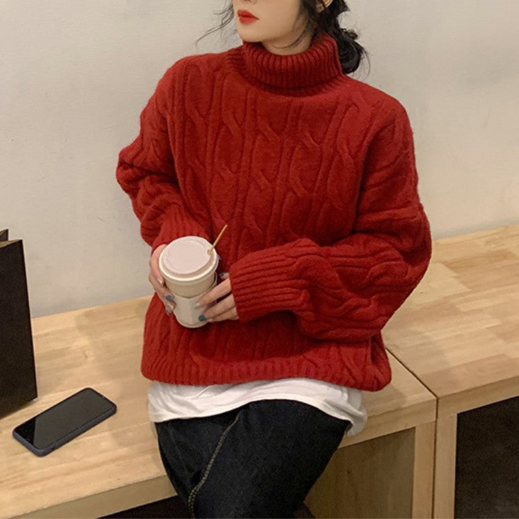 Women’s knit sweater with cable pattern and roll neck