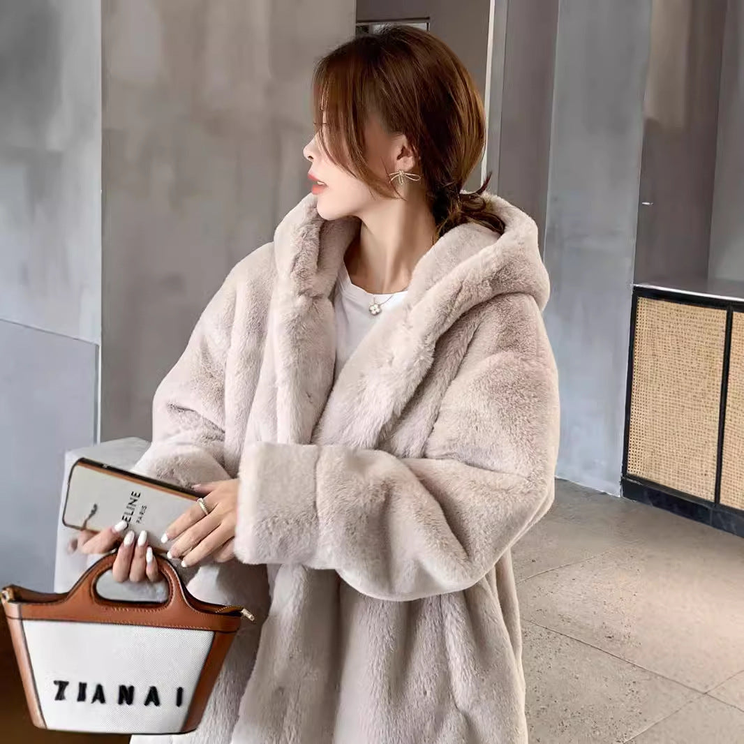 Long women's faux fur coat with hood and tailoring