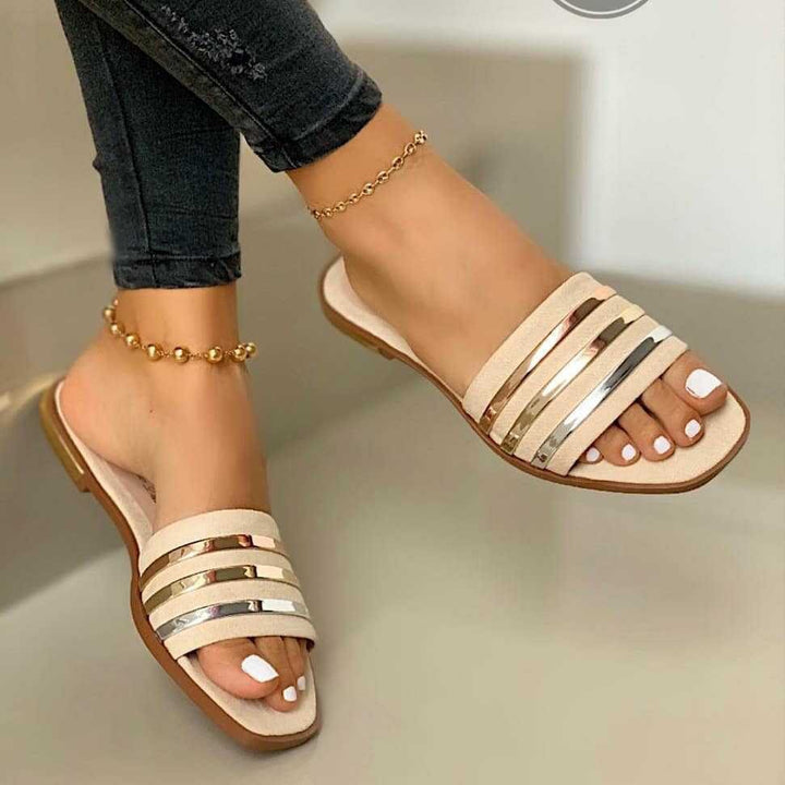 Ladies' flat slip-on sandals with multi-stripe metallic strips and padded comfort footbed Mune Fashion