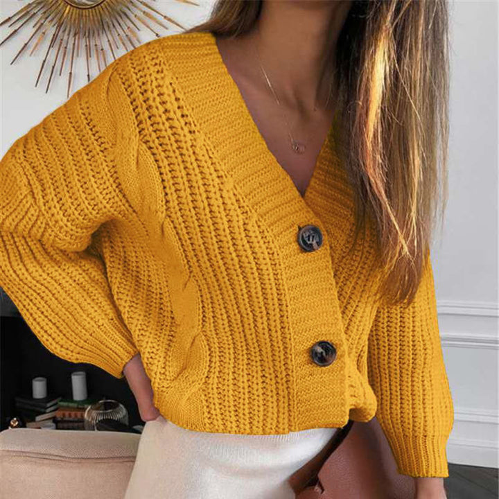 Women’s short cropped chunky knit cardigan with deep V-neck, cable pattern and oversized sleeves Mune Fashion