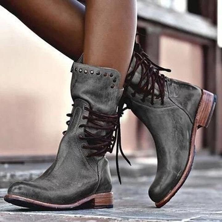 Women's rugged worker boots with decorative wrap lacing, metal eyelets, and profiled rubber outsole Mune Fashion