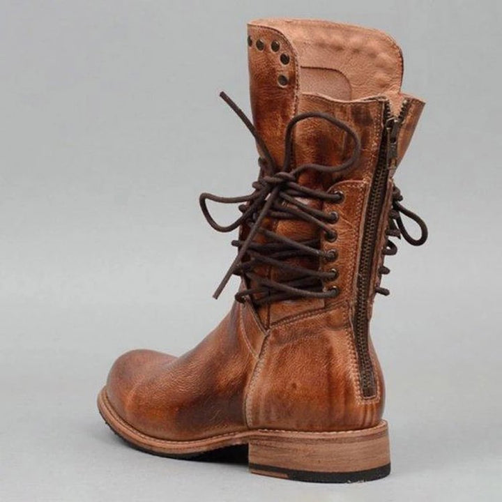 Women's rugged worker boots with decorative wrap lacing, metal eyelets, and profiled rubber outsole Mune Fashion