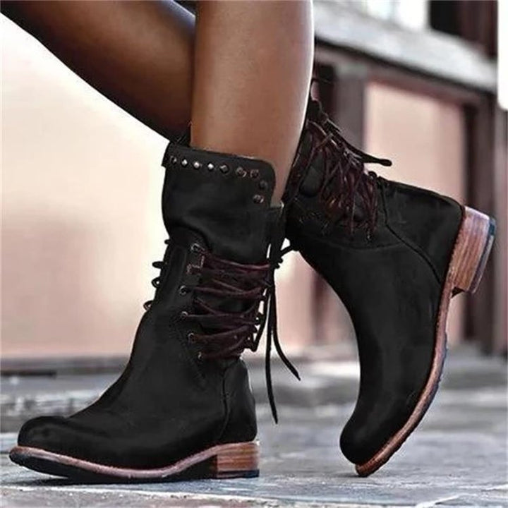 Women's rugged worker boots with decorative wrap lacing, metal eyelets, and profiled rubber outsole Mune Fashion