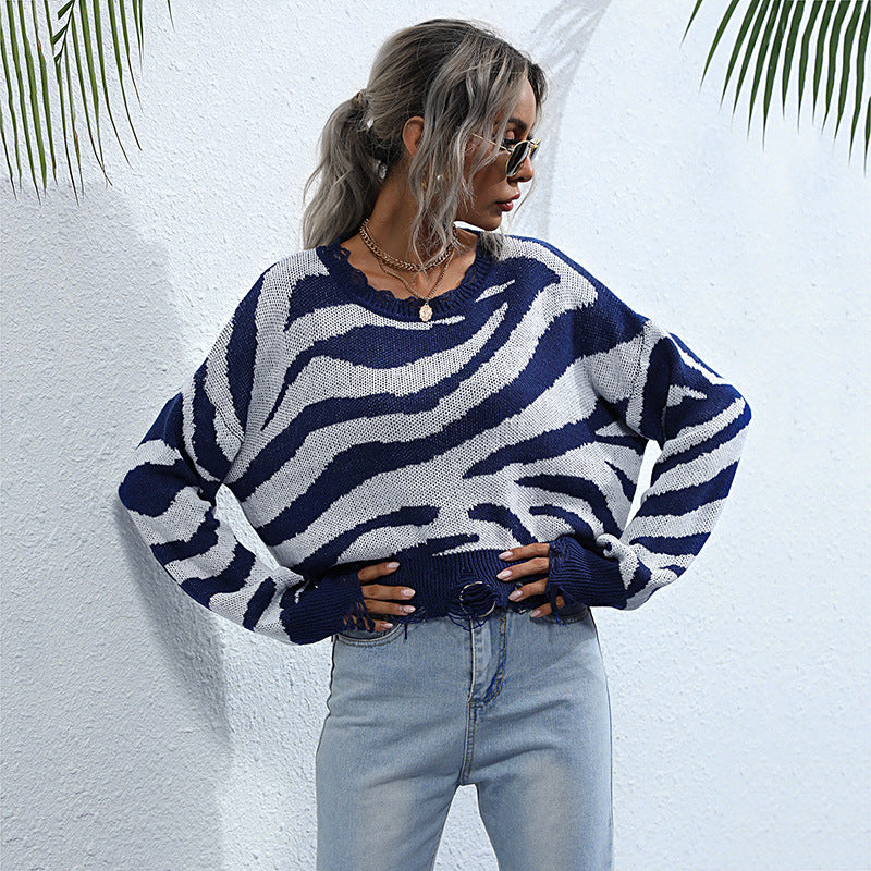 Women’s oversized knit sweater with zebra stripe jacquard, frayed hem, and raglan sleeves Mune Fashion