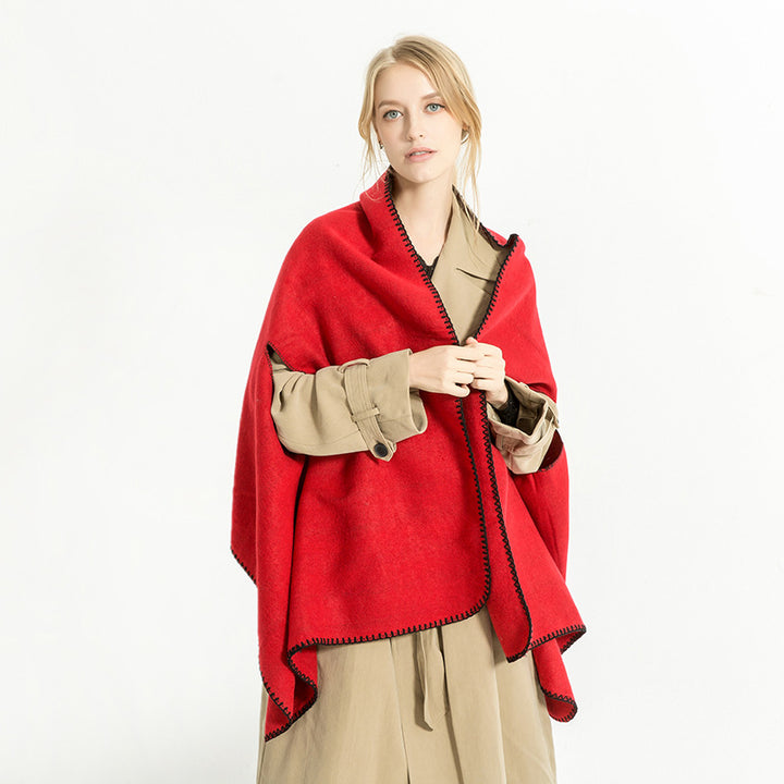 Women's oversized ruana poncho with arm openings and contrasting overlock stitching