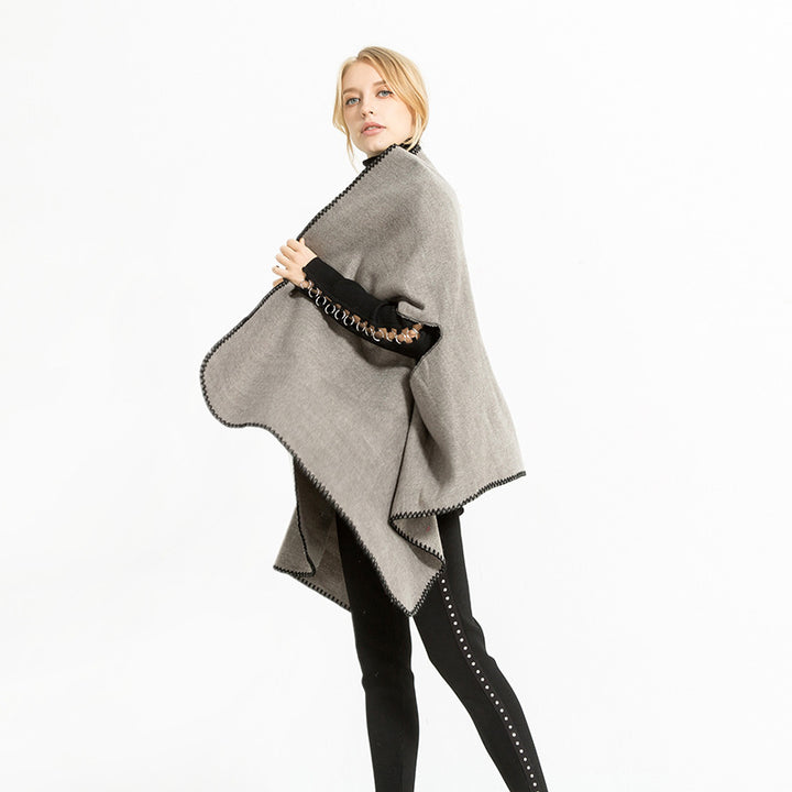 Women's oversized ruana poncho with arm openings and contrasting overlock stitching