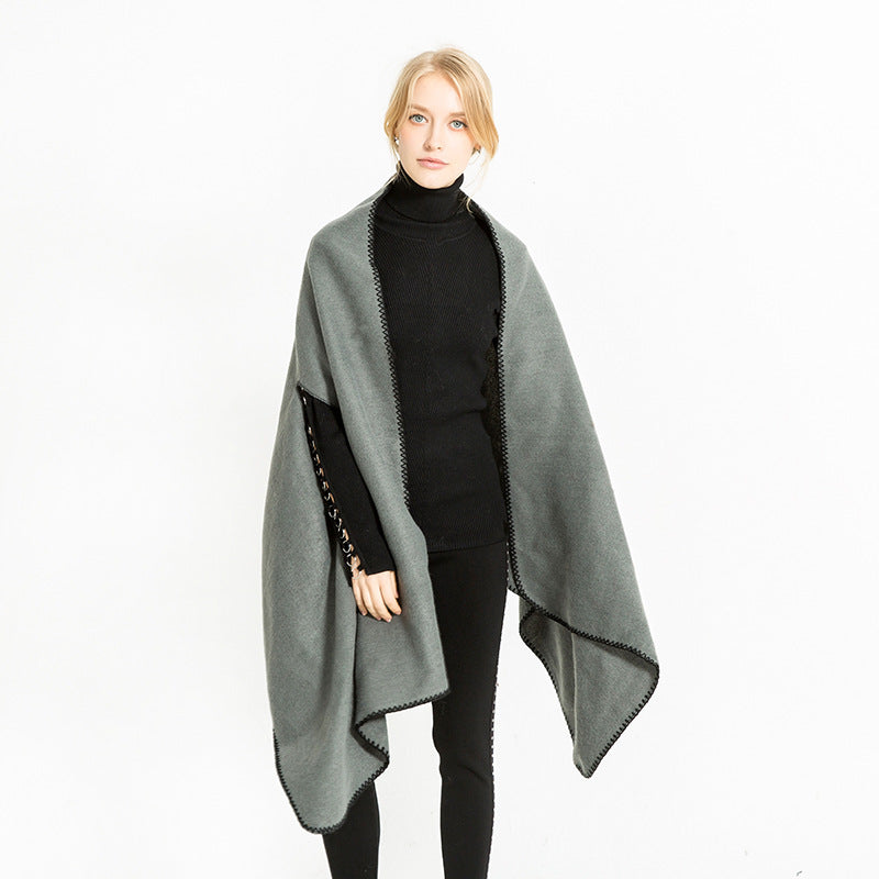 Women's oversized ruana poncho with arm openings and contrasting overlock stitching