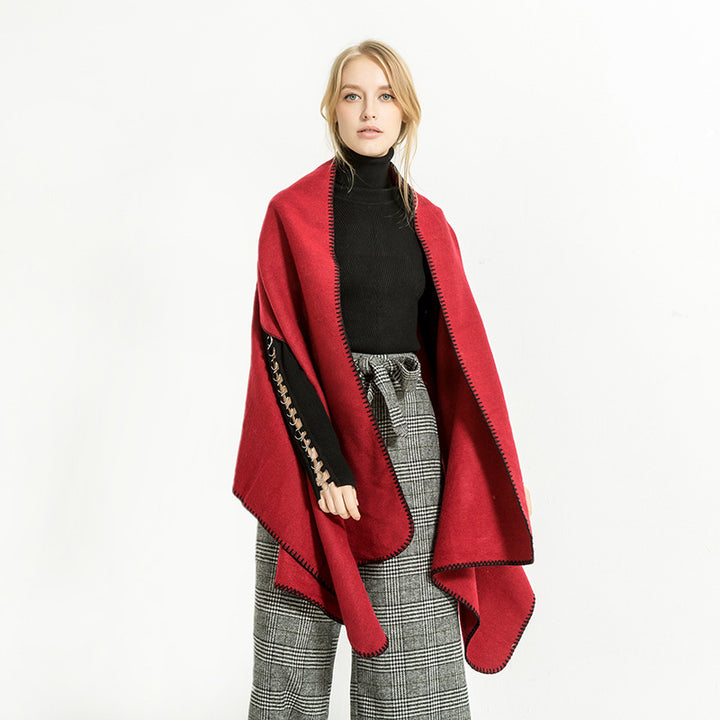 Women's oversized ruana poncho with arm openings and contrasting overlock stitching