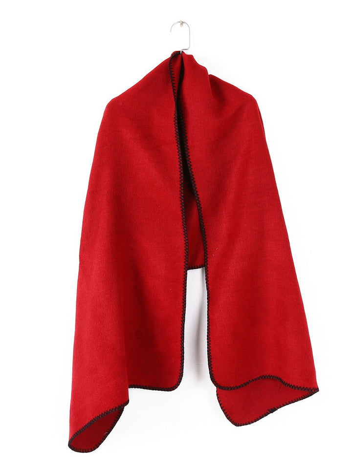 Women's oversized ruana poncho with arm openings and contrasting overlock stitching
