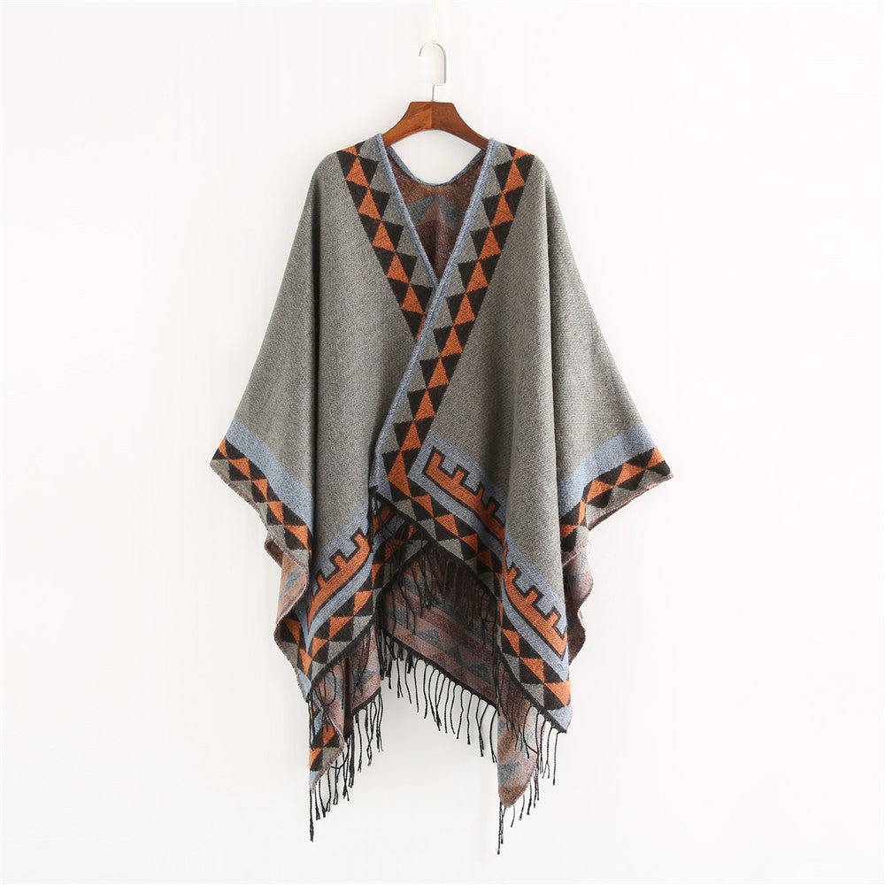 Women chunky knit poncho in wrap style with triangle jacquard and fringe hem Mune Fashion