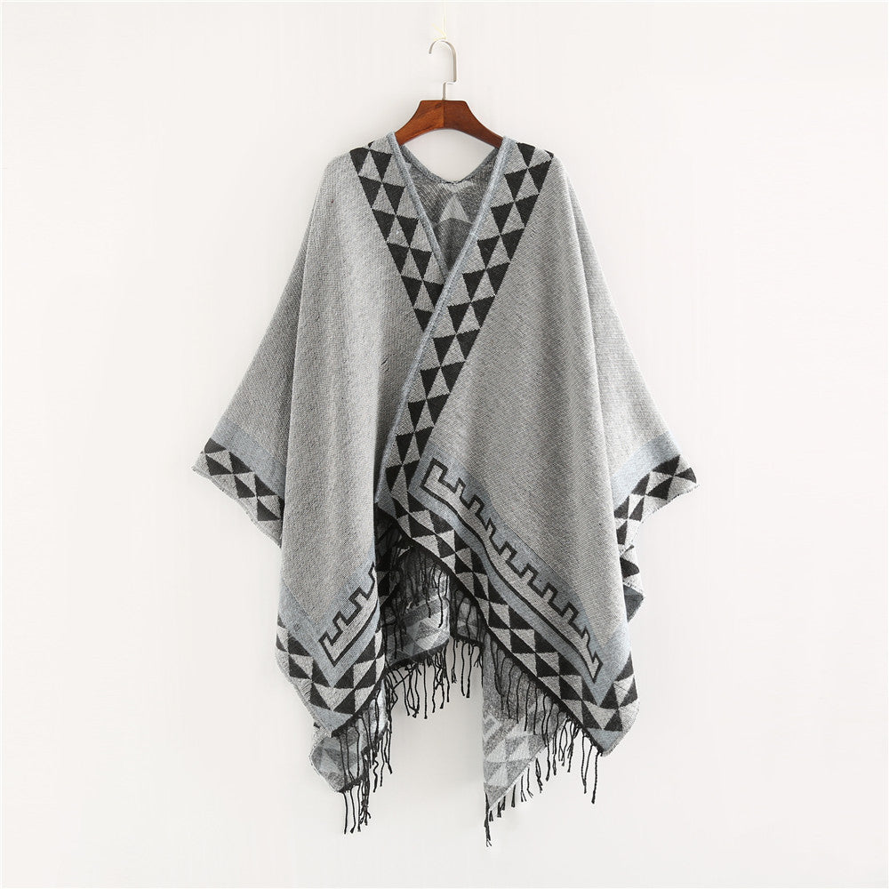 Women chunky knit poncho in wrap style with triangle jacquard and fringe hem Mune Fashion