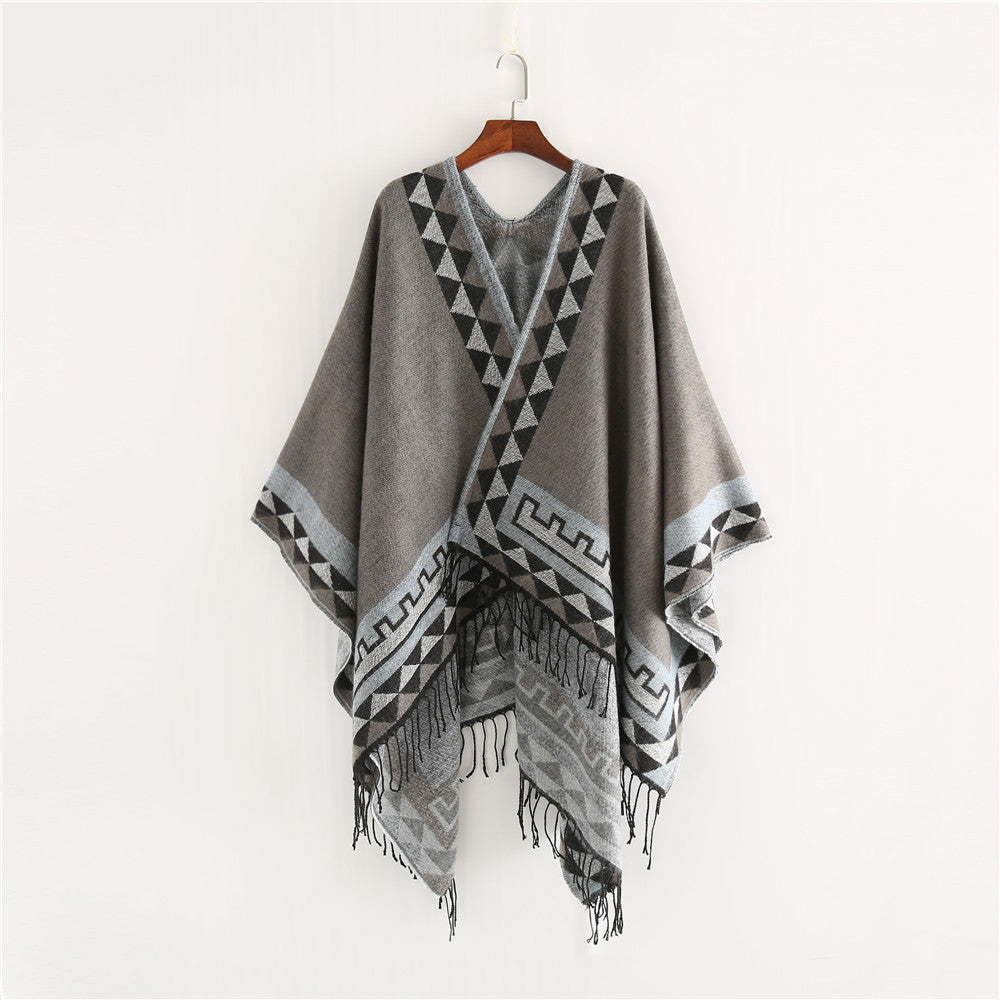 Women chunky knit poncho in wrap style with triangle jacquard and fringe hem Mune Fashion