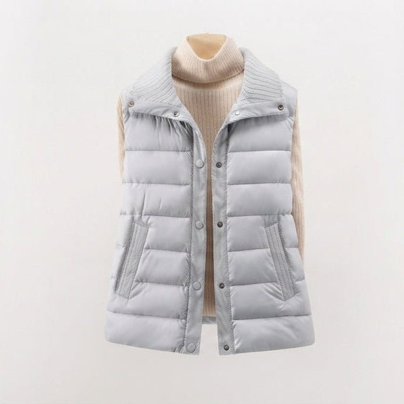 Women's non-padded quilted gilet with high ribbed shawl collar and concealed snap button placket