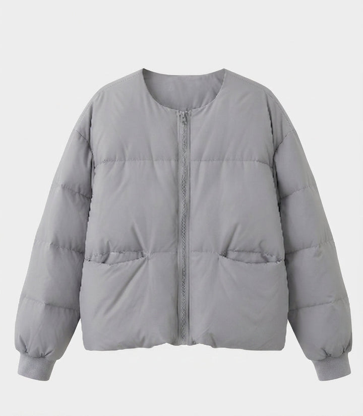 Women's short boxy quilted jacket with straight cut, concealed zipper, and elastic cuffs