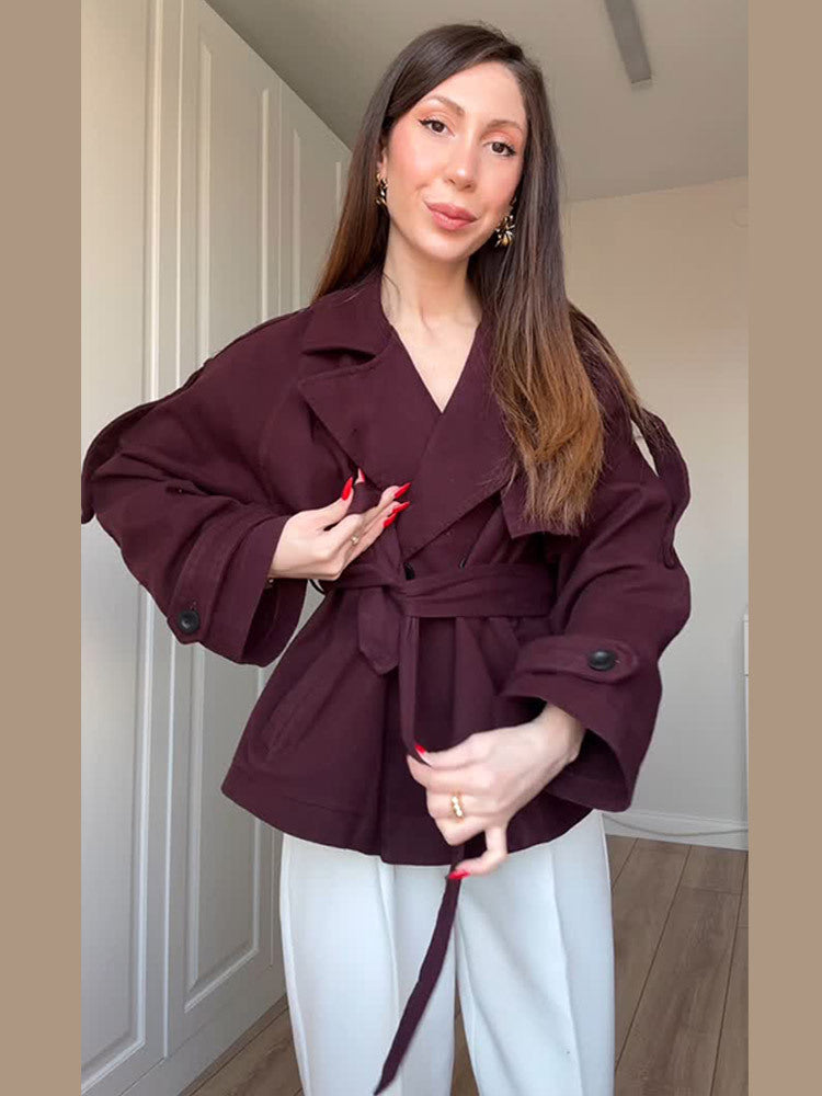 Women's short trench-style jacket with belted waist, oversized sleeves, and boxy cropped silhouette Mune Fashion