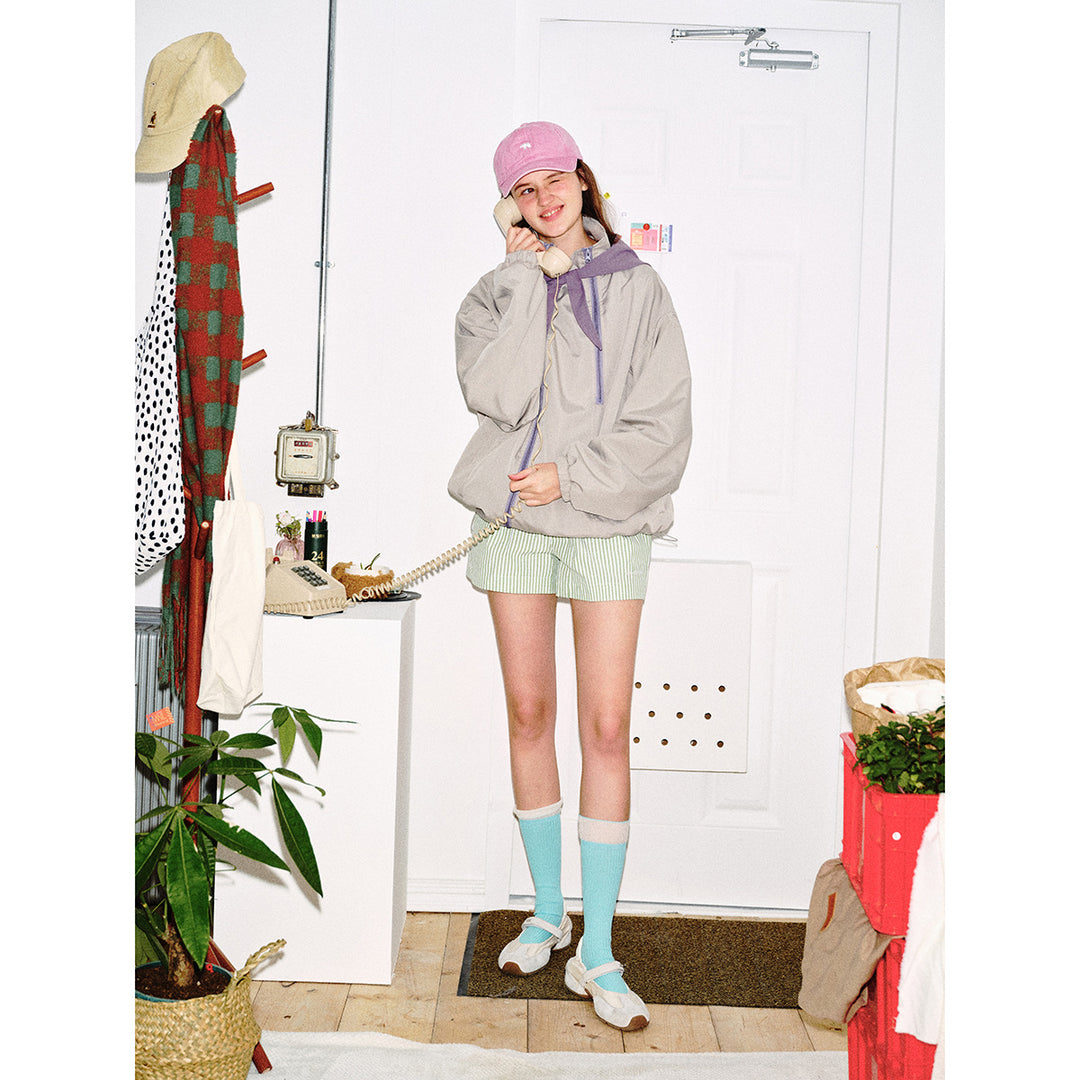 Unisex short cut technical windbreaker with asymmetric two-way zipper, detachable storm hood and shoulder mini bag Mune Fashion