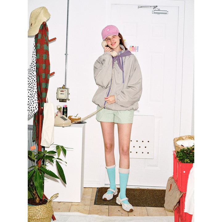 Unisex short cut technical windbreaker with asymmetric two-way zipper, detachable storm hood and shoulder mini bag Mune Fashion