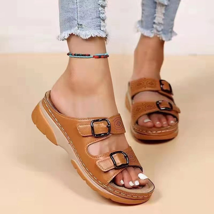 Women's double-strap slide with laser perforation, adjustable metal buckles, and padded wedge footbed Mune Fashion