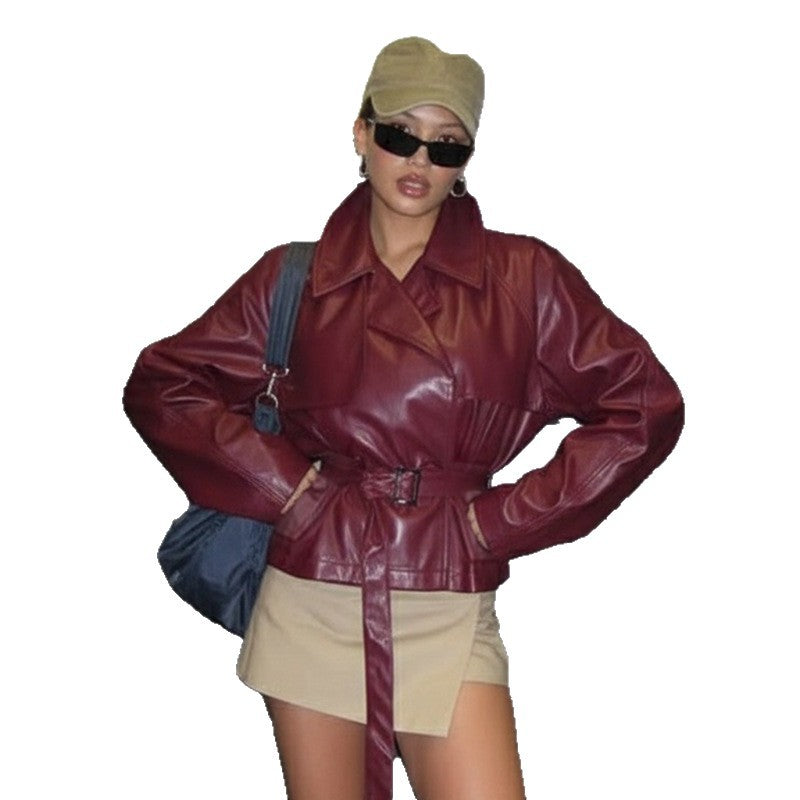 Women's short faux leather trench coat with waist belt, wide lapel and cape detail Mune Fashion