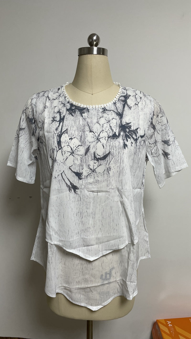 Women's two-layer blouse dress with asymmetrical tiered hem, floral print yoke, and wing sleeves Mune Fashion