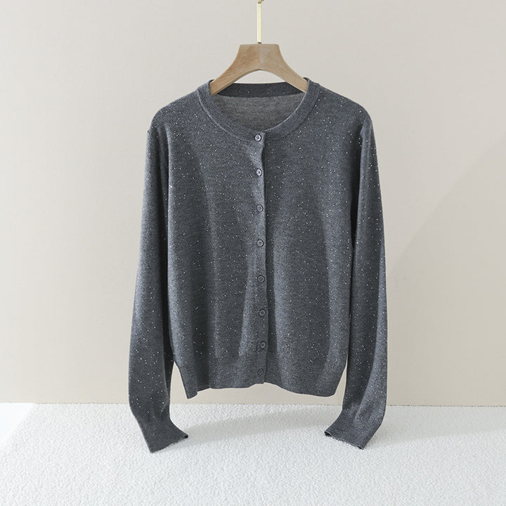Women's fine round neck cardigan made of lightweight fine knit with pearl button placket and subtle glitter effect.