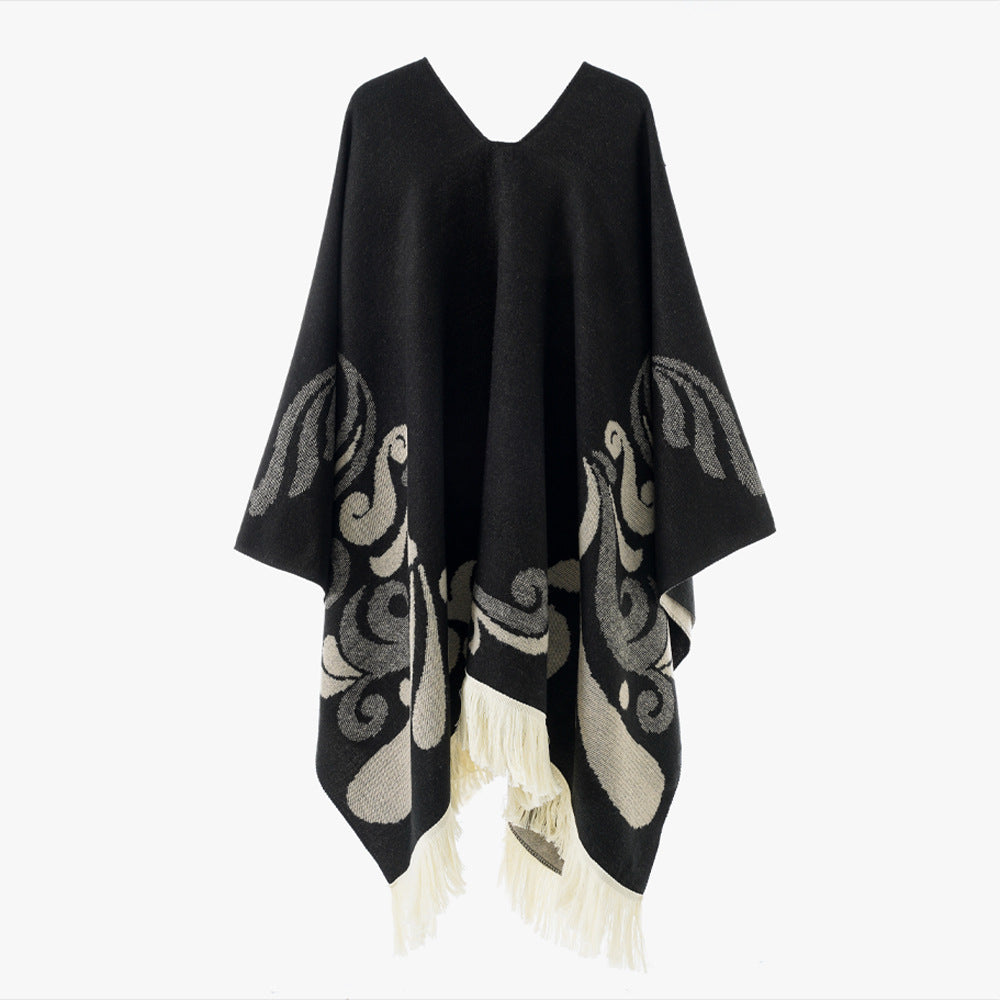 Women's wool blend poncho in cape style with V-neck, contrasting ornament jacquard and fringes.