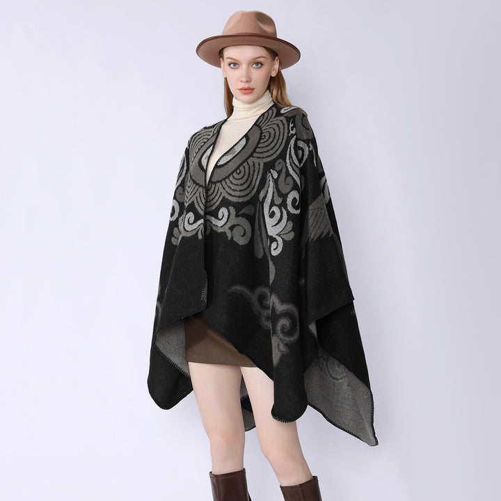Women's wool blend cape with ornamental jacquard, asymmetrical tip and soft falling oversized drape.